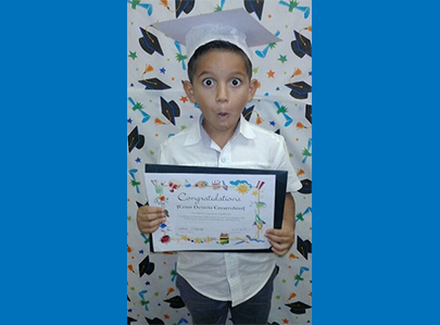 Boy with graduation cap and certificate
