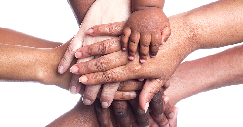 adult and children hands in unity