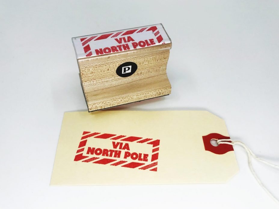 via north pole rubber stamp with tag